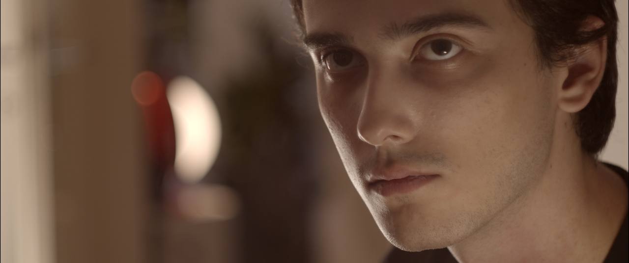 Close-up portrait in soft warm light from I Cocci Nel Muro.
